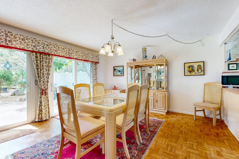 Enjoy shared meals during your beach stay in this spacious coastal dining room with plenty of seating and natural light. Perfect for family gatherings, game nights, or unwinding together after a day at the beach.