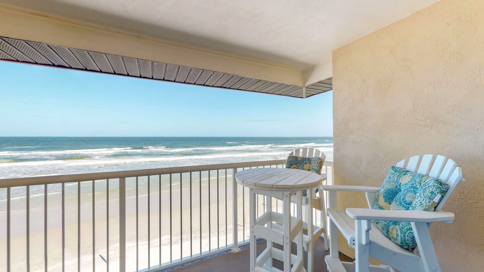 Relax on a private oceanfront balcony featuring Adirondack seating and endless sea views. This beach stay offers the perfect spot for morning coffee, ocean breezes, and unforgettable coastal sunsets just steps from the sand.