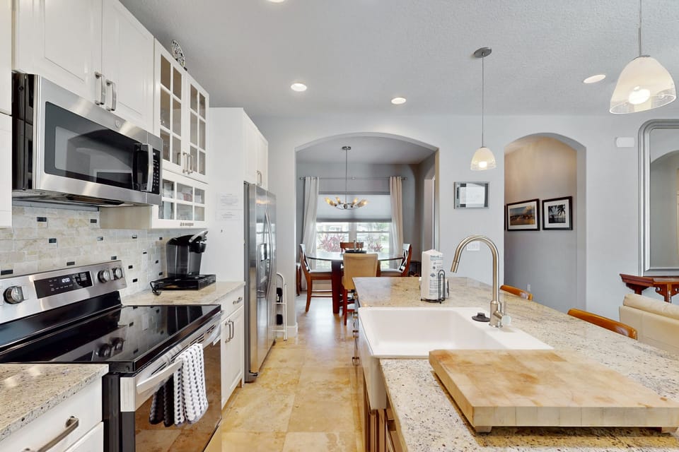 This bright coastal kitchen offers granite countertops, modern appliances, and an open flow to the dining area. Perfect for a relaxed beach stay, it's ideal for preparing meals and gathering after a day by the ocean.