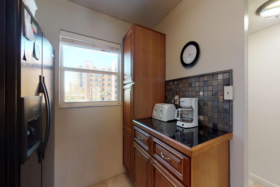 Start your beach stay right with this convenient kitchen nook featuring a coffee maker, toaster, and extra storage—perfect for quick breakfasts and easy mornings before heading to the beach.