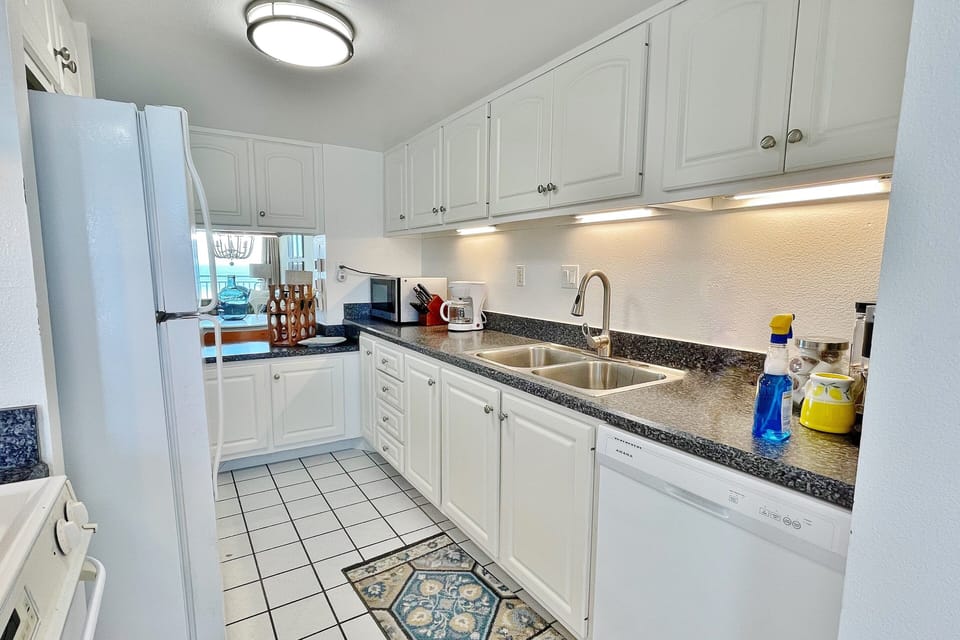 This clean, coastal kitchen offers full appliances, ample counter space, and everything needed to prepare meals at home—perfect for fueling up before beach days or relaxing nights during your beachfront vacation stay.