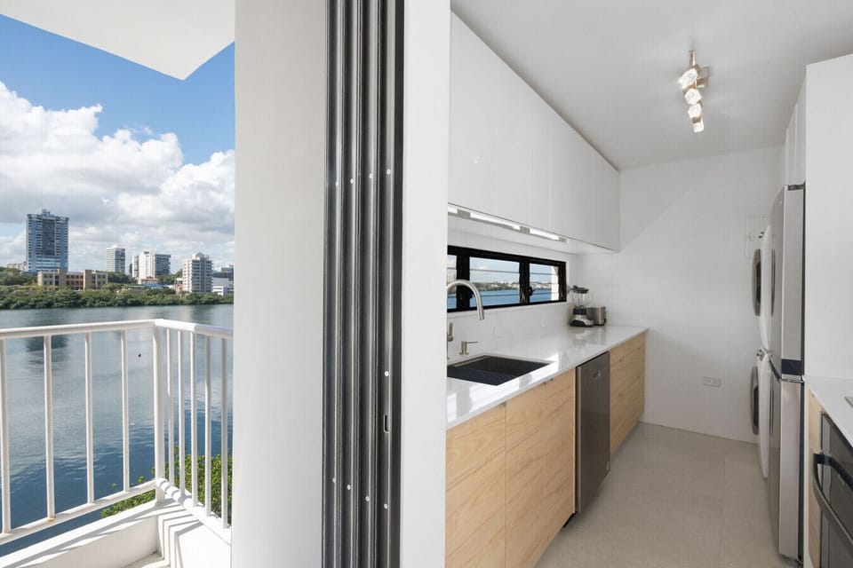A fully equipped, modern culinary space with inspiring water vistas