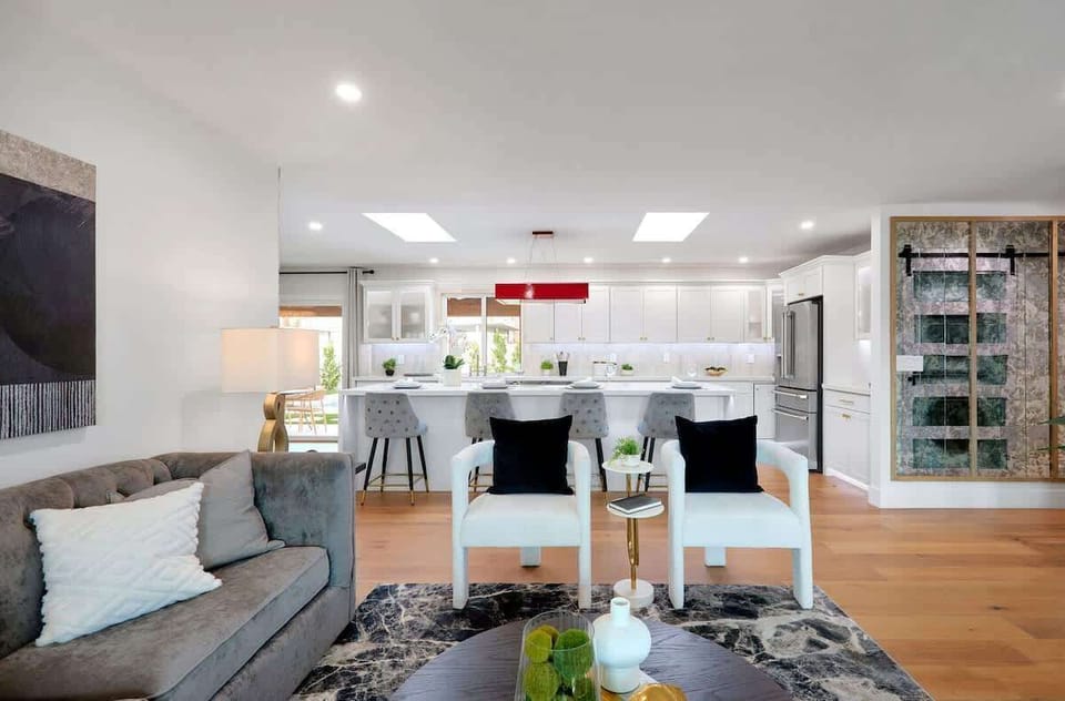 Open living area featuring a smart TV, plush furnishings, and a fireplace.