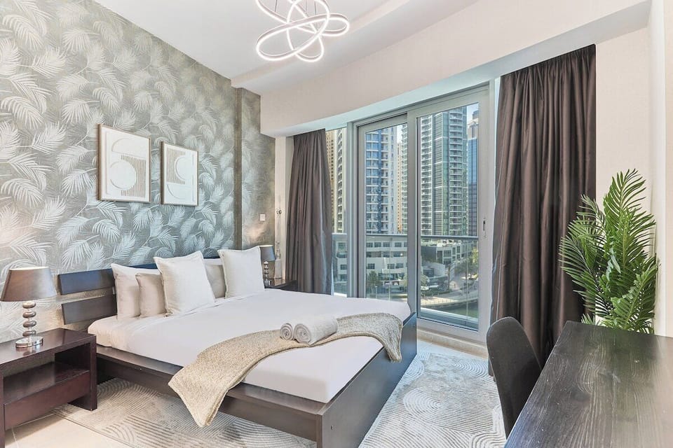 Rest and recharge in this elegant King bedroom, complete with a cosy workspace, stylish décor, and ample natural light.