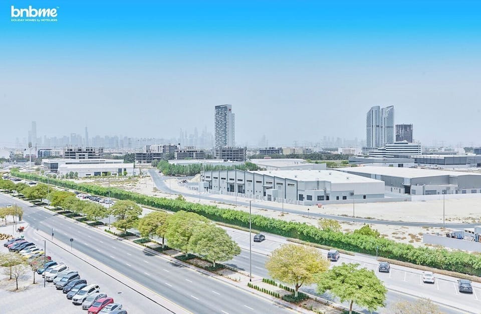 Private balcony with outdoor seating for two, perfect for enjoying morning coffee or evening drinks. Offers open road &amp; city views and a refreshing breeze, creating a relaxing spot to unwind after exploring Dubai.