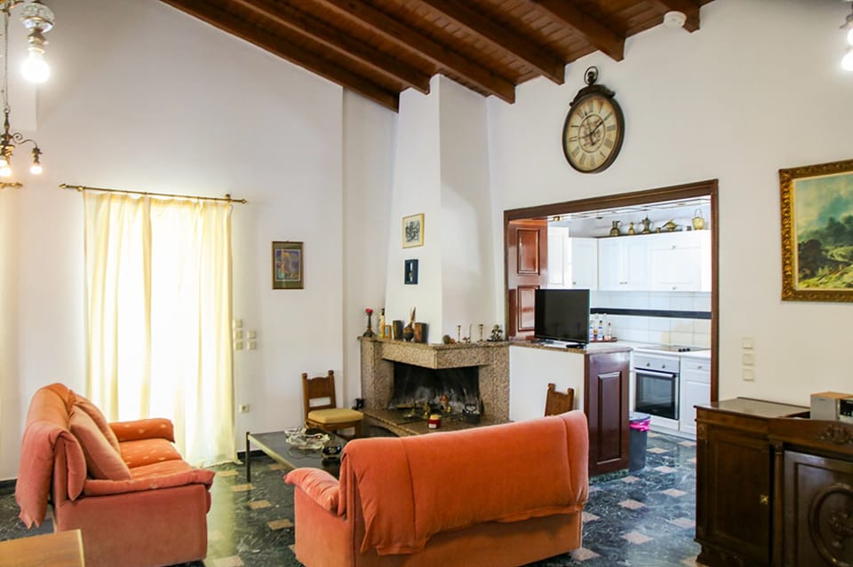 Main living room shot showcasing comfortable seating, decorative touches, a TV and an inviting layout for relaxation