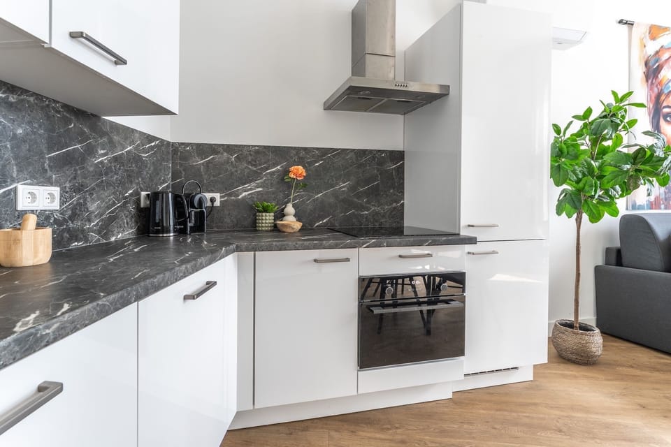 Prepare delicious meals in a modern kitchen featuring quality appliances, ample workspace, and stylish finishes.