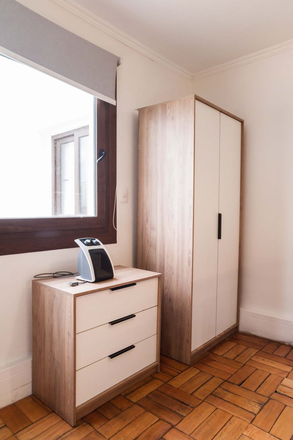 Cozy corner with ample storage and natural light, perfect for a comfortable stay.