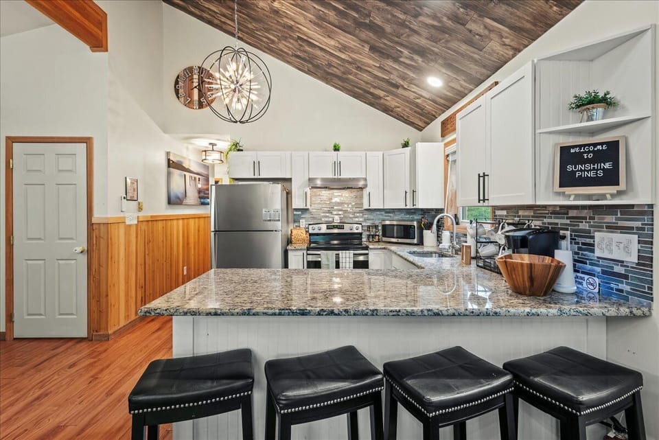 Cook, gather, and connect in this fully equipped kitchen featuring stainless steel appliances, granite counters, and cozy cabin charm.