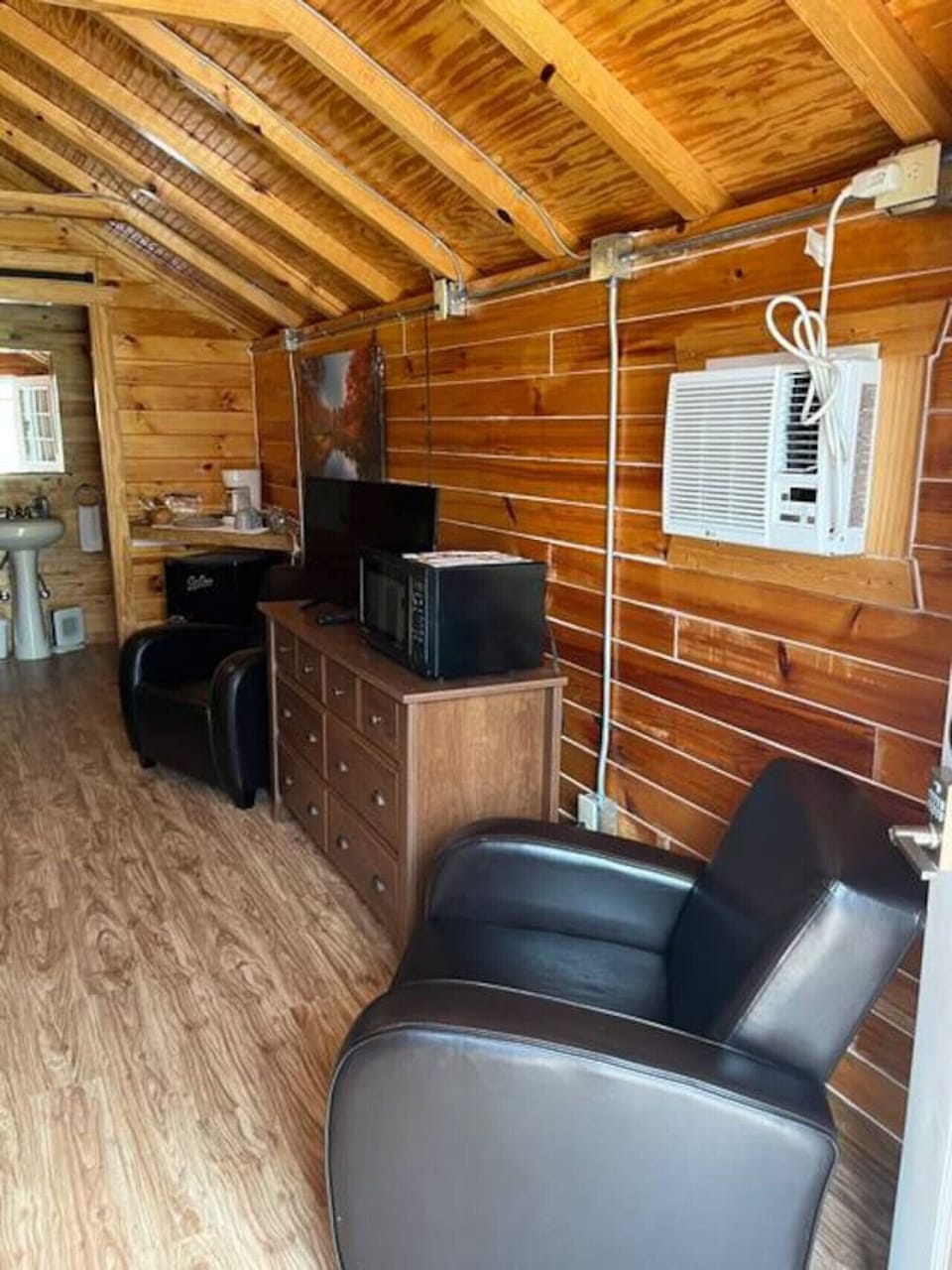 Chill, stream, and snack with two comfy seats, AC, smart TV, and microwave.