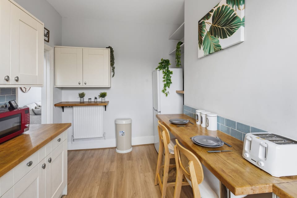 This fully equipped kitchen features a large refrigerator and plenty of cabinet storage, perfect for stocking up on supplies for long stays or family cooking.