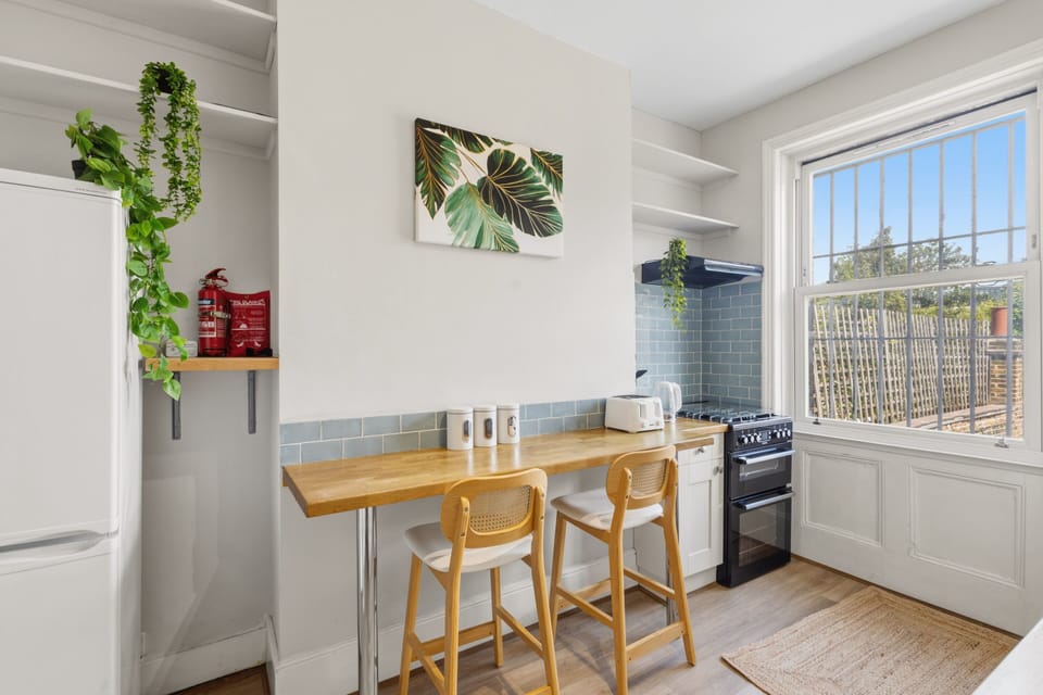 A spacious, well-lit kitchen featuring a modern breakfast bar, creating a wonderful social hub for cooking and casual dining during your group stay or family holiday.