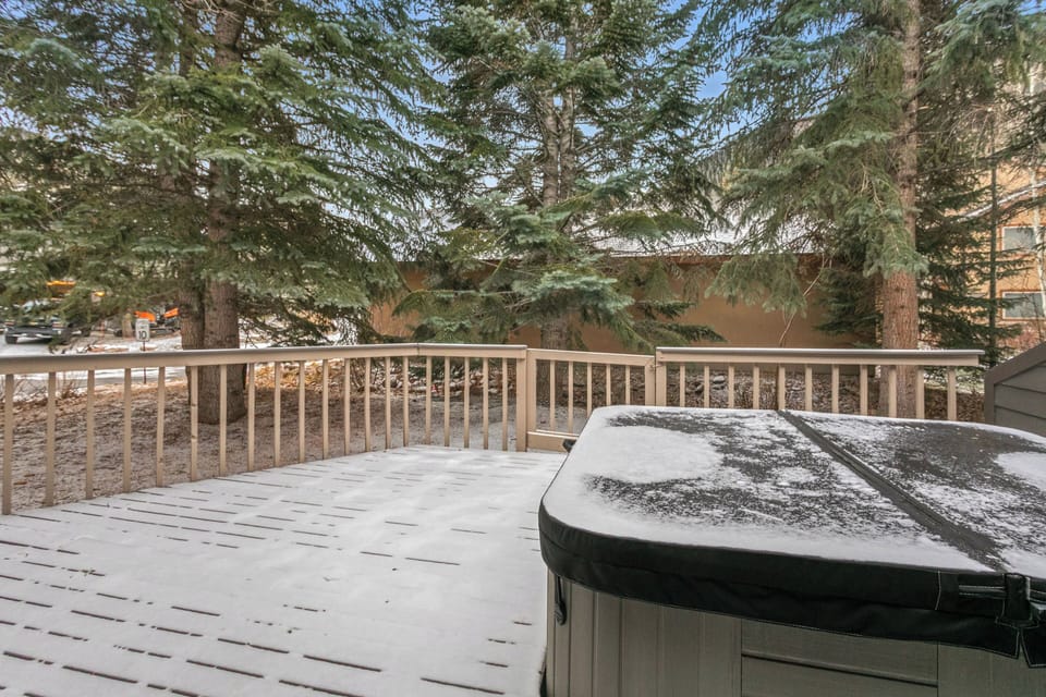 Relax in your private hot tub on the spacious deck, surrounded by towering evergreens and peaceful natural scenery.
