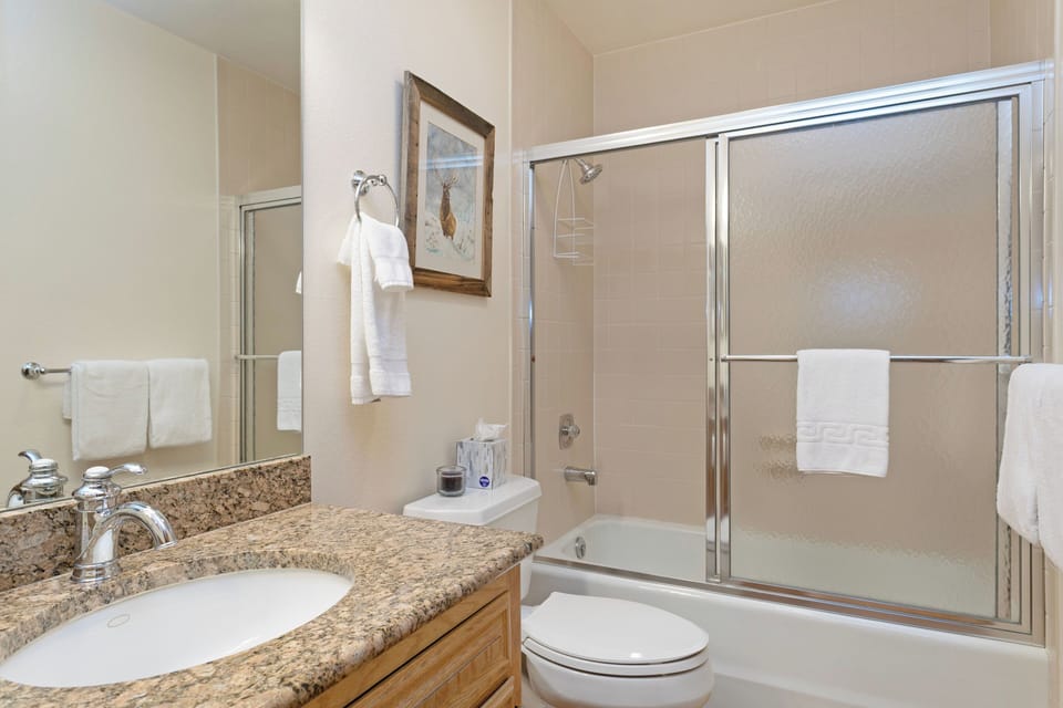 Upper level guest bathroom with shower/tub combo.