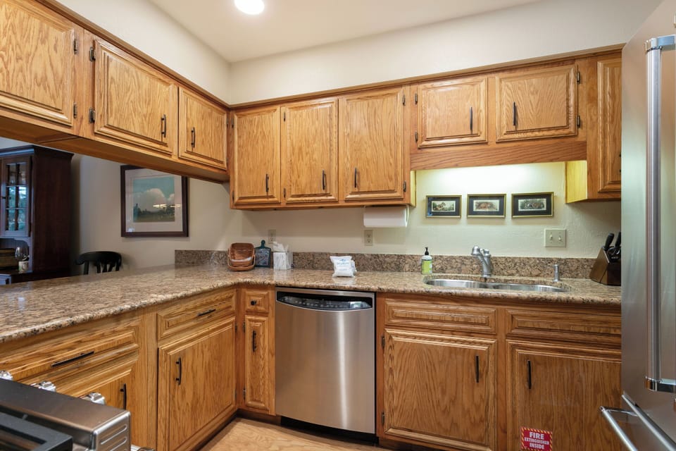 Your fully equipped kitchen features granite countertops, stainless steel appliances, and beautiful oak cabinetry, making meal preparation a pleasure during your stay.
