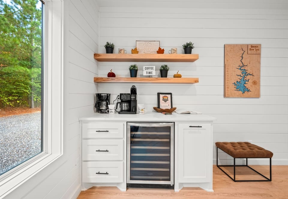 Coffee and wine bar with forest views and open shelving.
