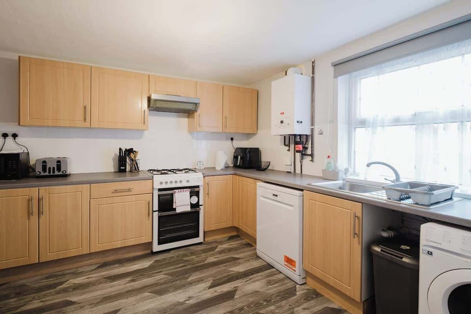 A bright, modern kitchen with plenty of workspace and appliances, ideal for preparing meals during your stay.