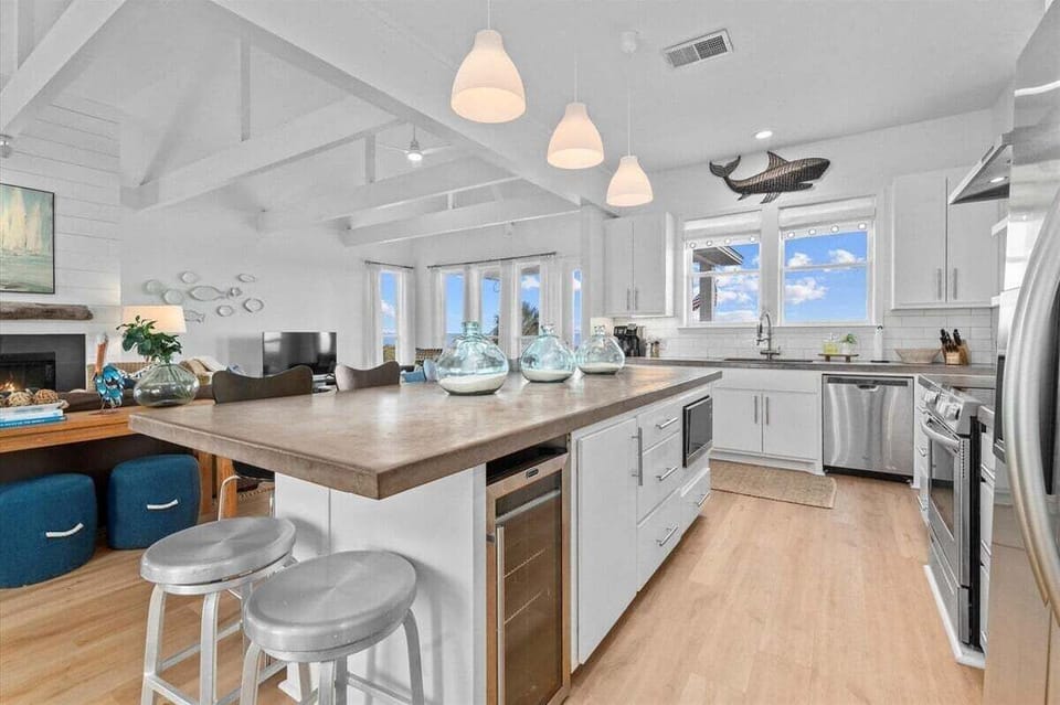 Large kitchen island with seating, pendant lighting, and open layout – chef-friendly space
