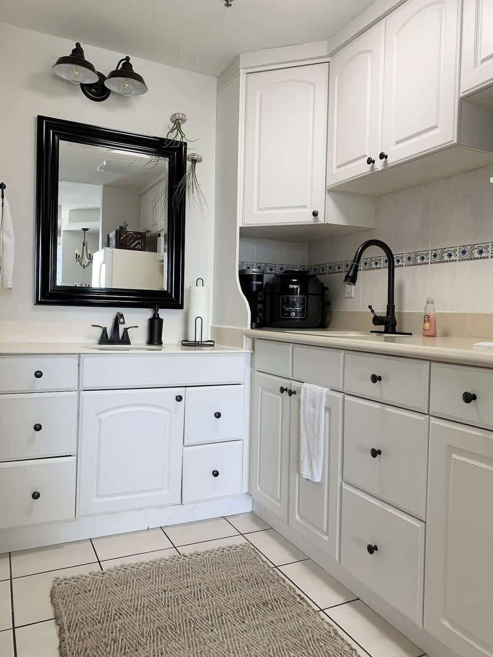 - Clean kitchenette with white cabinets and essential appliances
- Compact design perfect for easy meals and quick snacks
- Includes sink, storage, and functional prep space for stays    
