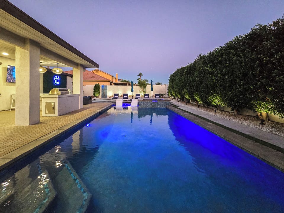 Resort style backyard-pool, spa, poolside and in-pool loungers and umbrellas