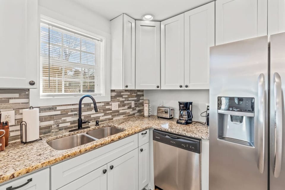 Kitchen with 12 cup coffee maker, coffee bean grinder, and toaster oven