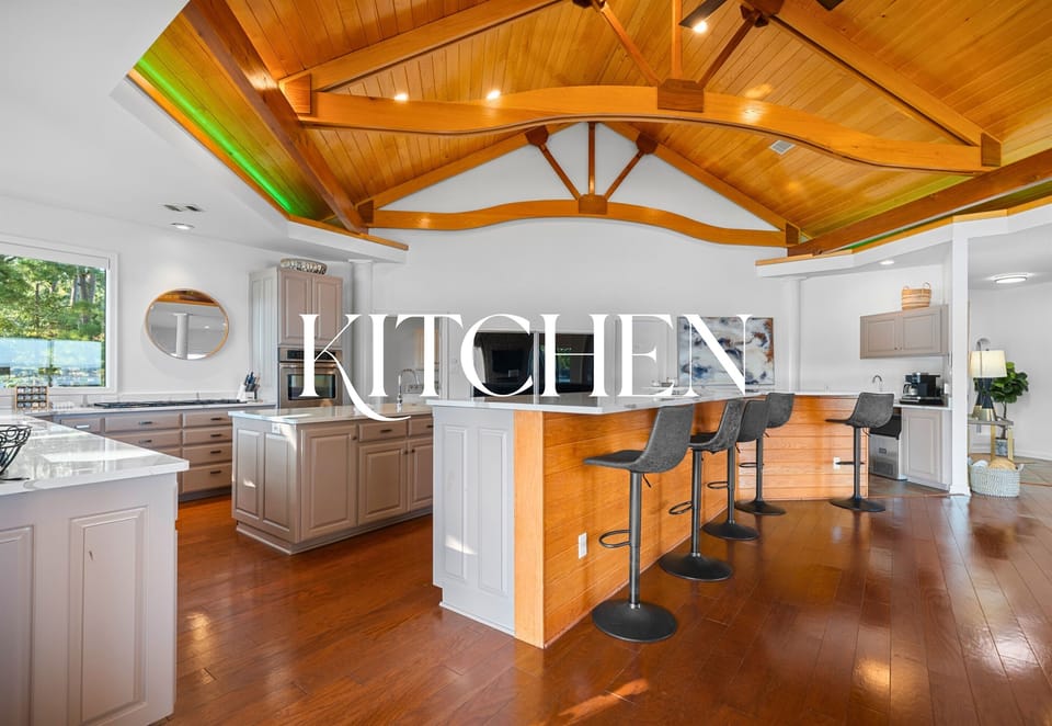 Chef’s kitchen with vaulted ceilings, island seating, and open flow.