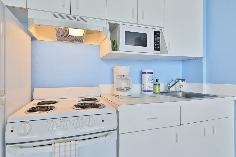 This beach stay kitchen offers full appliances, ample storage, and a bright coastal feel—perfect for preparing meals before or after a relaxing day at the beach during your seaside vacation.