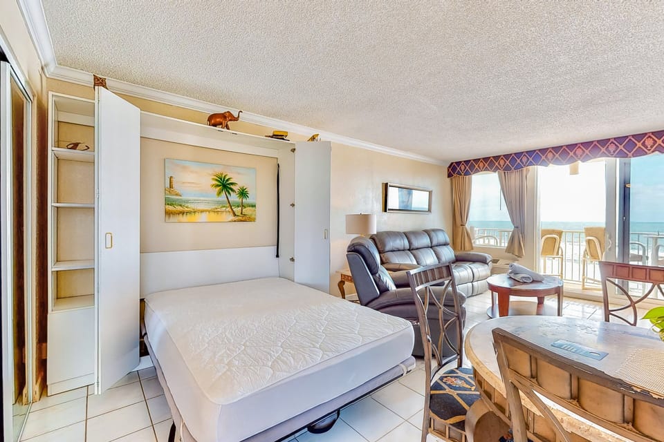 Enjoy flexible comfort during your beach stay with this oceanview living space featuring a convenient Murphy bed, cozy seating, and balcony access. Perfect for daytime relaxation and added sleeping space by night.