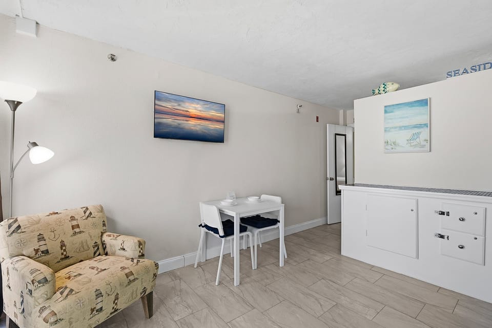 This cozy coastal living area is perfect for your beach stay, offering comfortable seating, a dining nook, and beach-inspired décor. A welcoming space to relax and recharge after time spent by the shore.