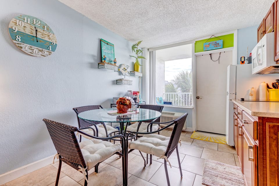 Enjoy meals in this charming beach-inspired dining area with natural light, coastal décor, and a cozy setup—perfect for starting or ending your relaxing beach stay just steps from the shore.