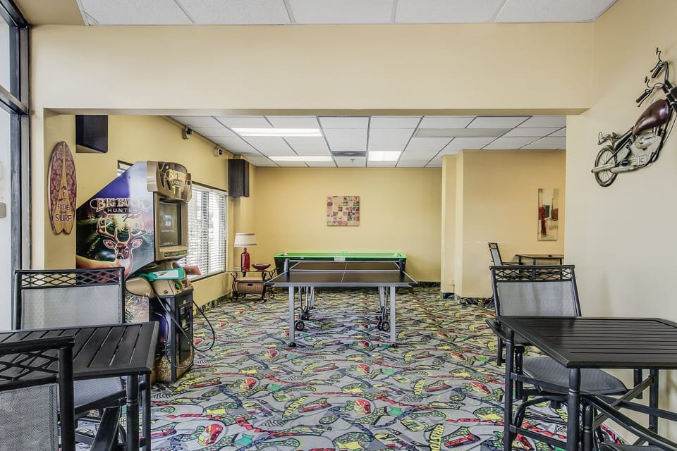 Enjoy downtime in this on-site game room featuring ping pong, arcade games, and seating. A fun addition to your beach stay, perfect for family-friendly entertainment after a day at the shore.