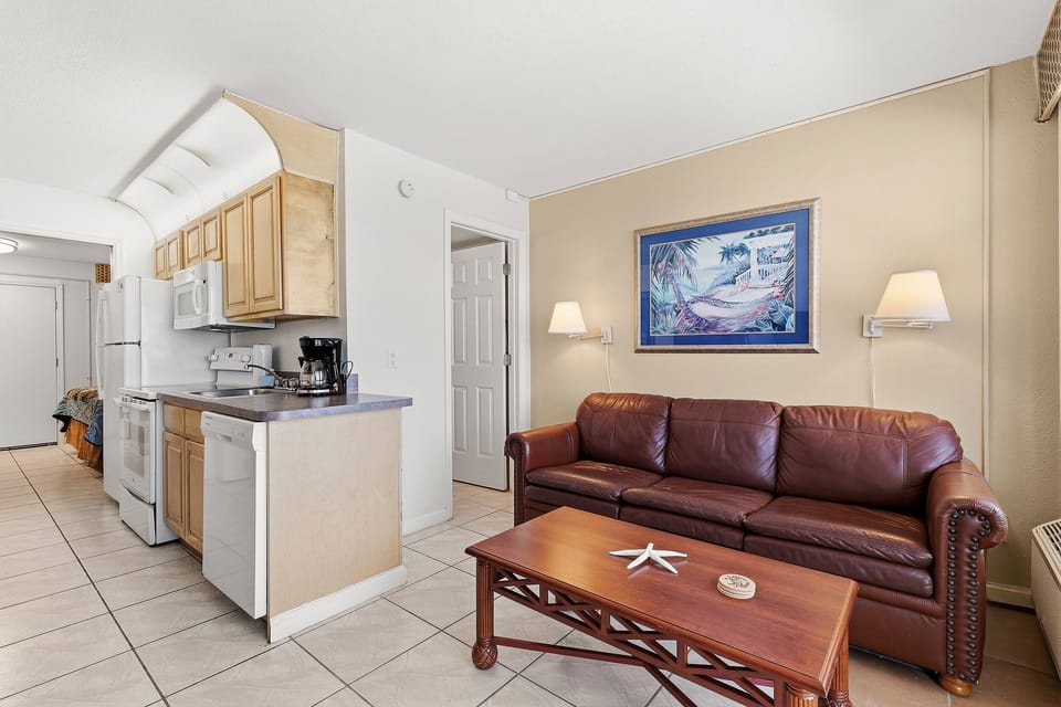 Enjoy a comfortable beach stay in this bright condo featuring a cozy living area and fully equipped kitchen. Relax on the sofa after a day at the beach and enjoy the open layout designed for easy coastal living and seaside getaways.