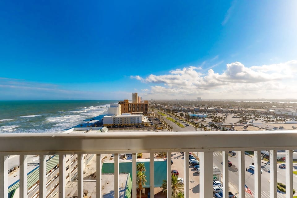 Stunning oceanfront balcony view perfect for your beach stay. Enjoy sweeping coastline vistas, bright blue skies, and the best of coastal living right from your private balcony. Relax and take in the breathtaking scenery.