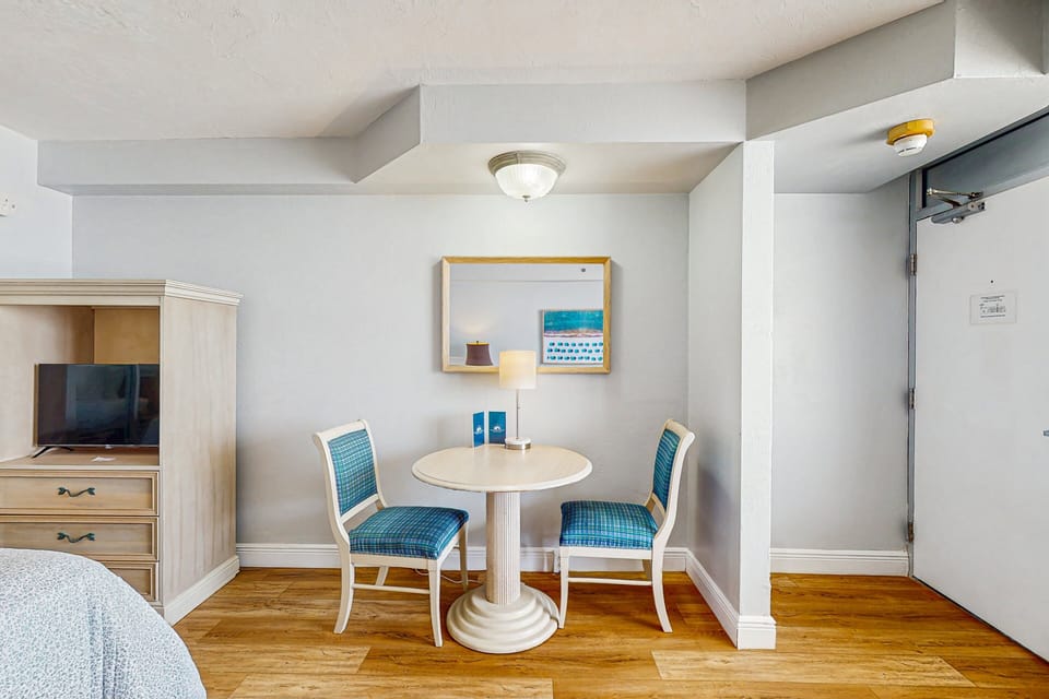 Charming dining area with seating for two, perfect for meals or morning coffee. This cozy setup adds comfort and convenience to your beach stay, ideal for relaxing indoors between ocean adventures.
