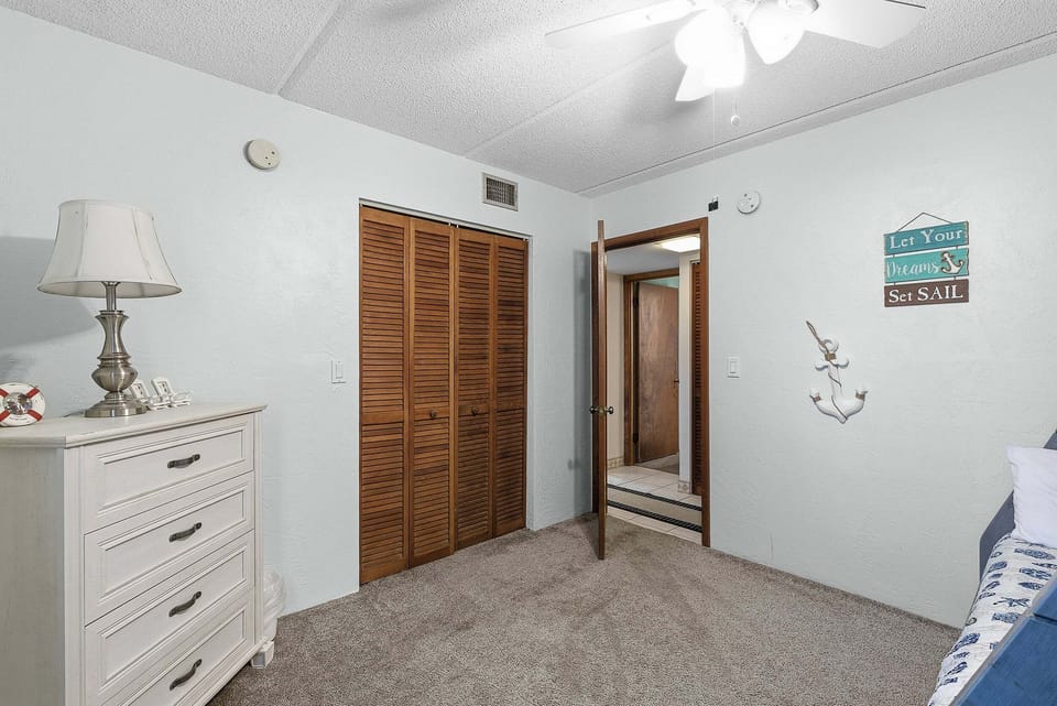 This cozy bunk room is perfect for your beach stay, featuring nautical décor, comfortable bedding, and ample space. A great retreat for kids or guests to relax after a day of sun, sand, and seaside fun.