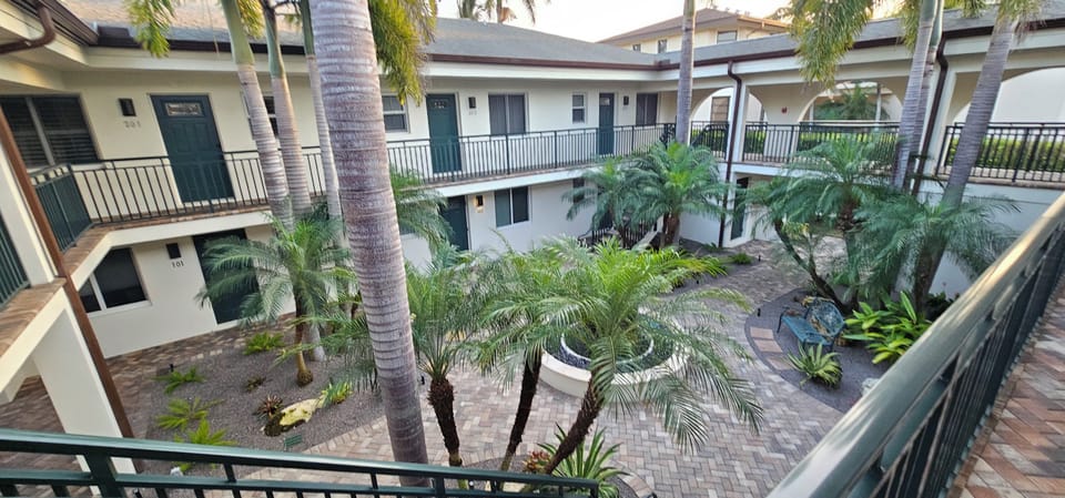 View of quiet walkway connecting units through a peaceful garden setting