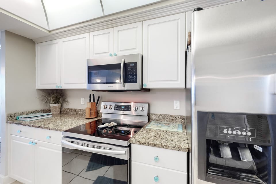 This bright, fully equipped coastal kitchen features modern appliances and ample counter space—perfect for preparing meals and snacks during your relaxing and convenient beach stay.