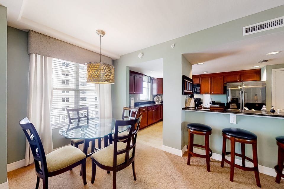 Sunny dining space and open kitchen create the perfect setting for relaxed beach-day meals. Enjoy coastal comfort with plenty of seating and natural light during your beach stay.