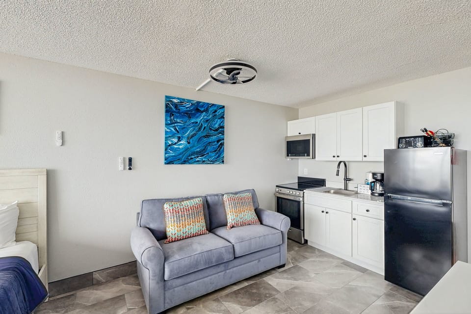 Relax in this bright beachfront studio featuring a sleeper sofa, modern kitchenette, and coastal décor. Designed for a comfortable beach stay, it's the perfect spot to unwind after a day of sun, sand, and ocean views.