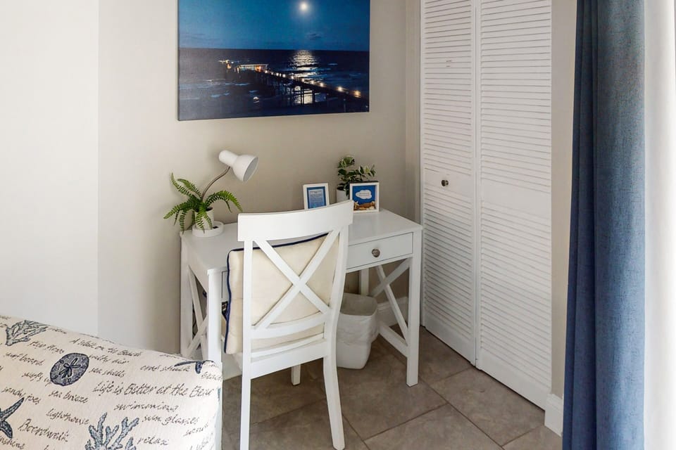 Balance work and relaxation during your beach stay with this cozy coastal work nook, featuring a bright desk space and calming décor—perfect for remote work between beach days.