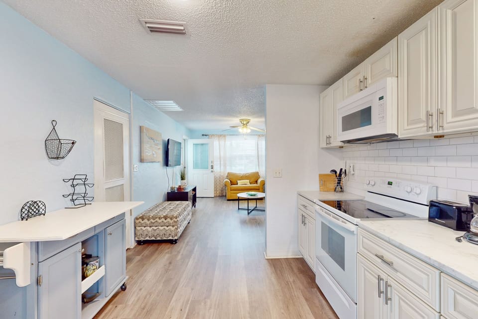 This bright beach stay features a fully equipped kitchen with modern appliances and a seamless flow into the cozy living area. Perfect for cooking, relaxing, and gathering after a sun-soaked day at the beach.