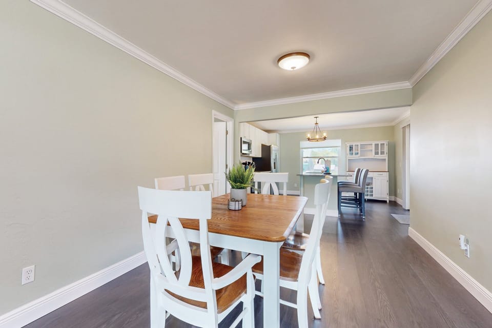 Spacious dining area perfect for gathering after a fun beach day. Enjoy coastal charm, natural light, and easy flow to the kitchen—ideal for your relaxing beach stay.