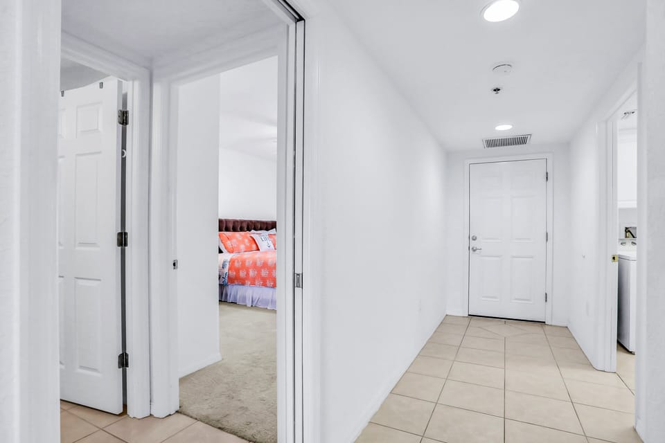 This clean, light-filled entry hallway offers easy access to bedrooms and living spaces. A welcoming start to your beach stay, it provides a smooth transition from the shore to comfortable coastal living.