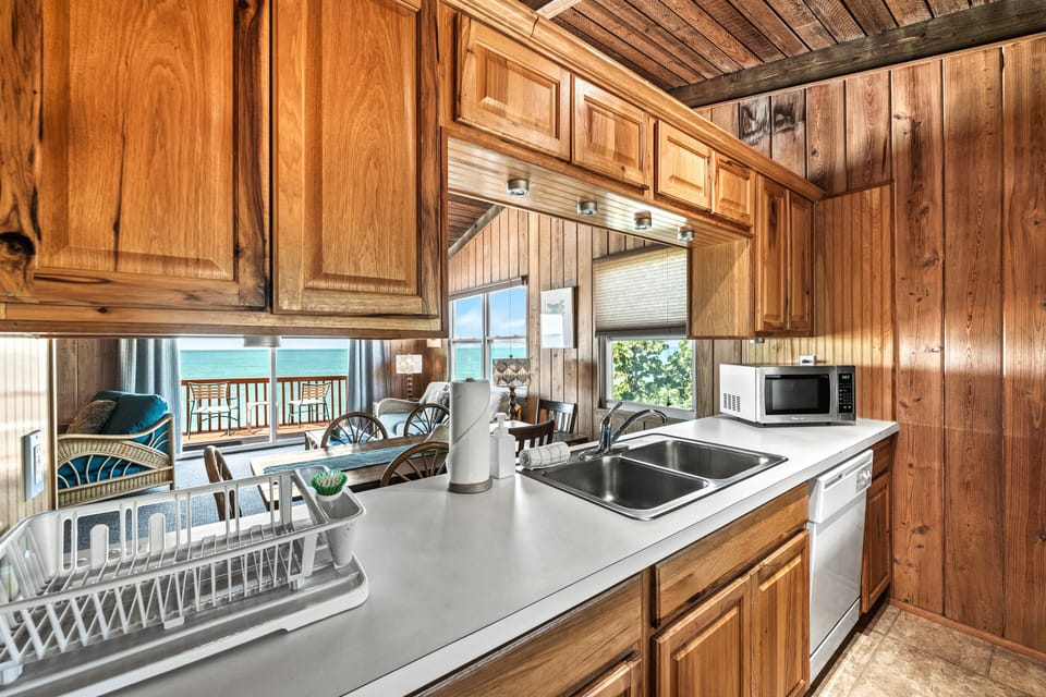 Kitchen featuring a distant Gulf view, where meal prep meets the serenity of sparkling waters beyond.