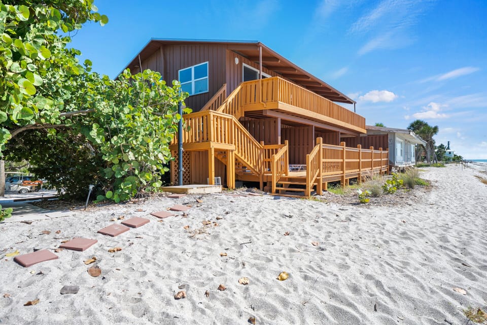 Partitioned deck sections and stairs are framed by sunlight, emphasizing the unit's private yet connected feel.