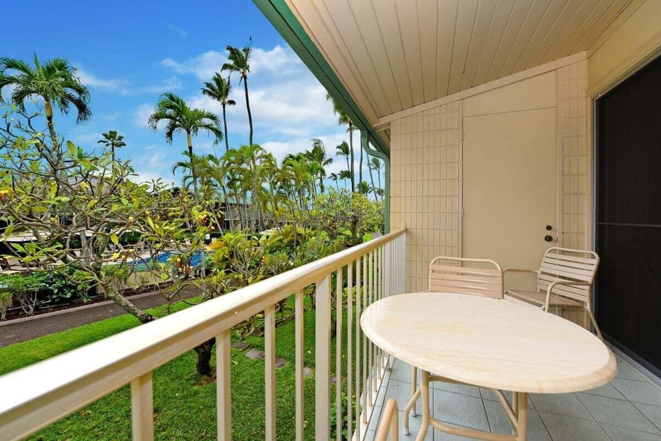 Start your day with tropical sights and gentle breezes from this cozy balcony, perfect for quiet moments or casual dining.