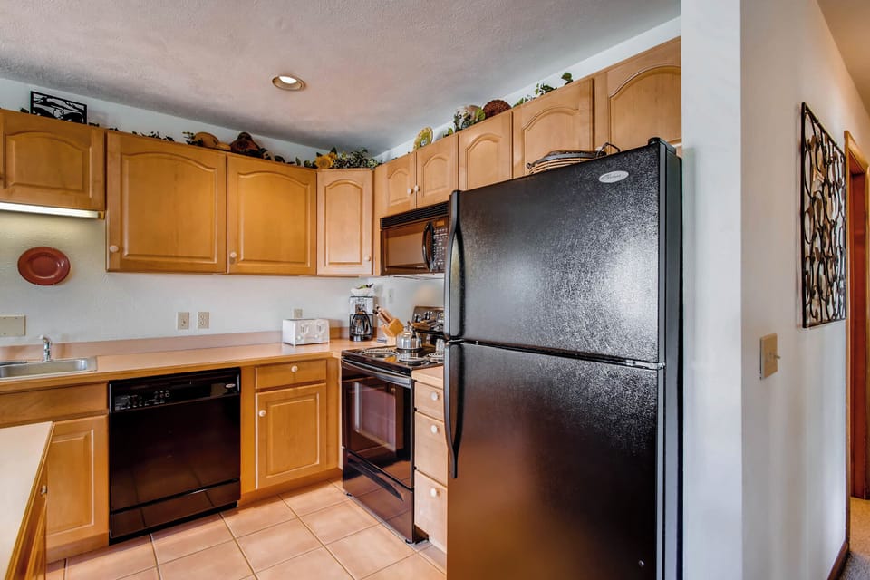 The fully equipped kitchen in Evergreen 3 boasts modern appliances and ample counter space, making meal preparation a breeze amidst the tranquil alpine setting.