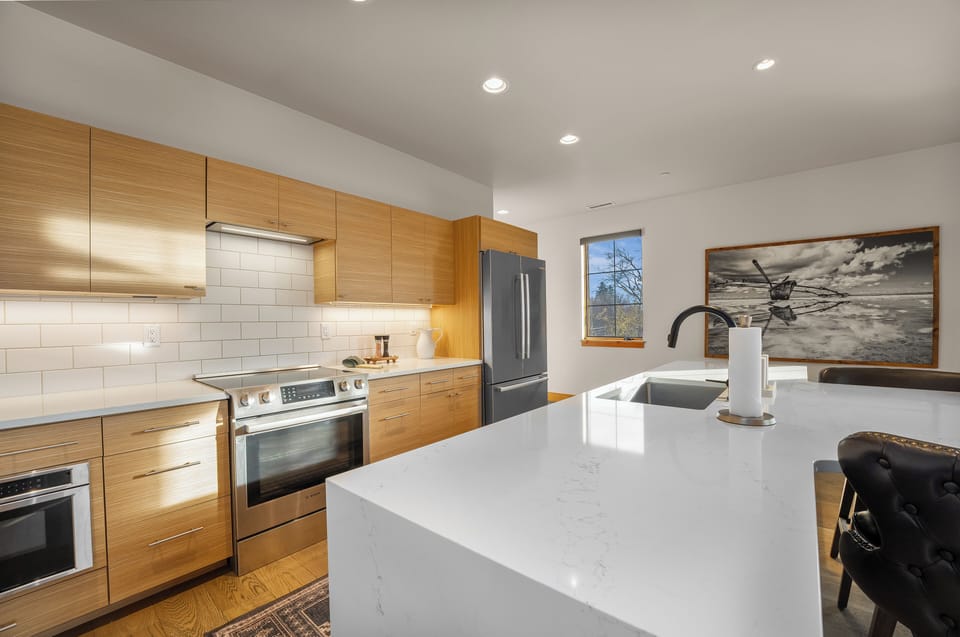 Sleek wood cabinets with stainless steel appliances.