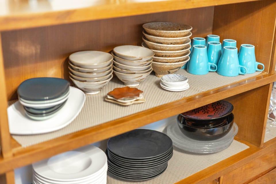Fully stocked kitchen shelves at Showa House Tokyo, providing guests with a wide range of tableware.