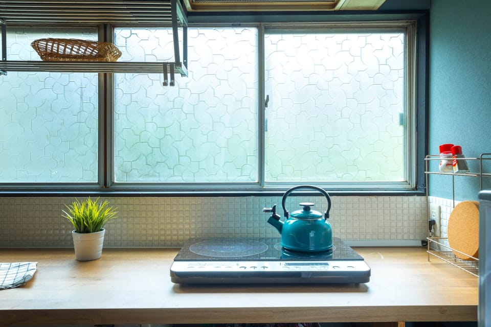 Functional retro kitchen with kettle and counter space for family cooking.